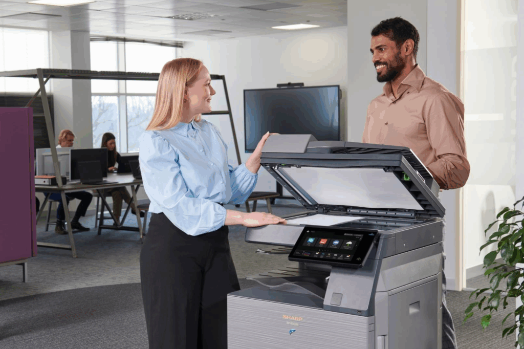 woman with man in office setting scanning documents