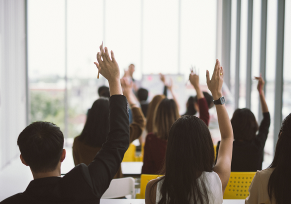 group setting with people with their hands up