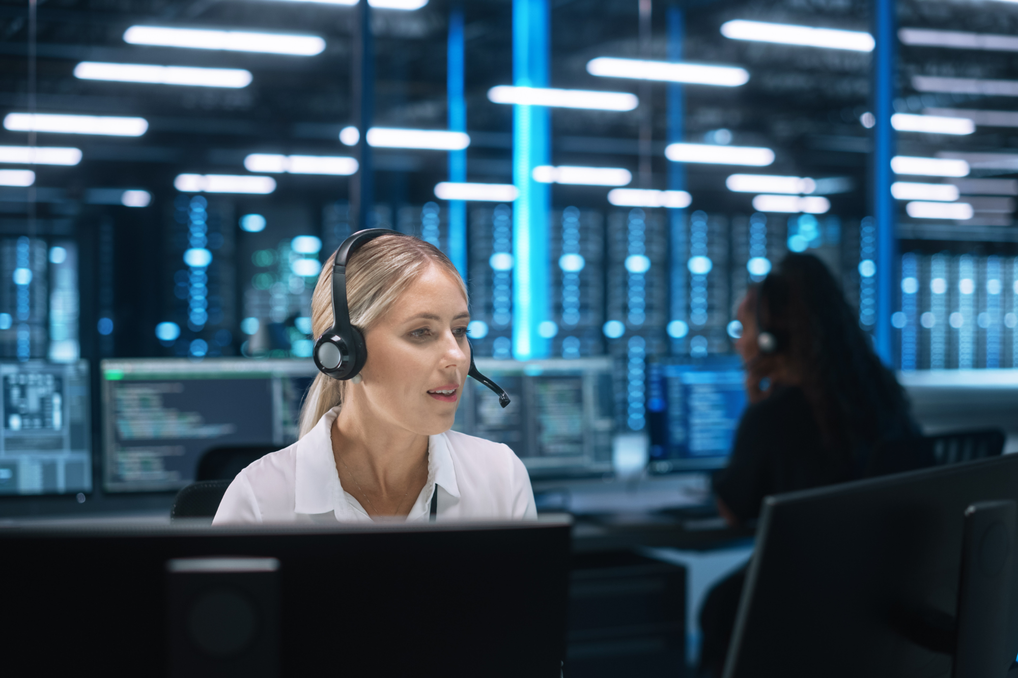 female with a headset on in a help centre